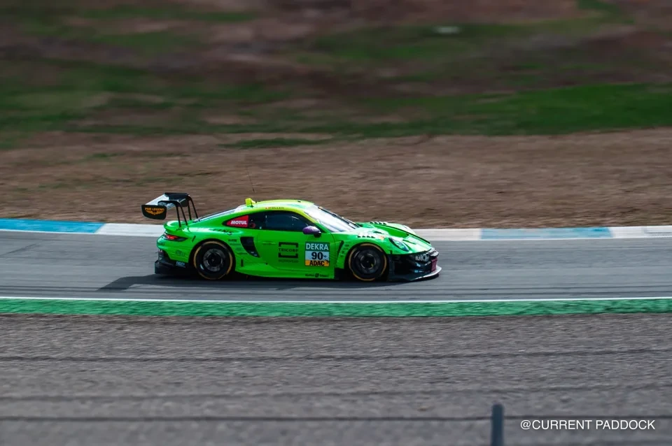 Green Porsche racing through a corner at Hockenheimring
