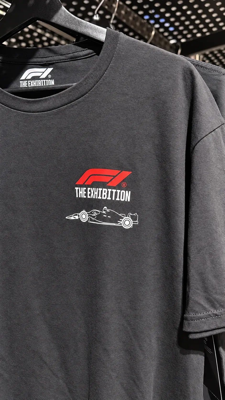 F1 The Exhibition t shirt hanging on a rail in the gift shop