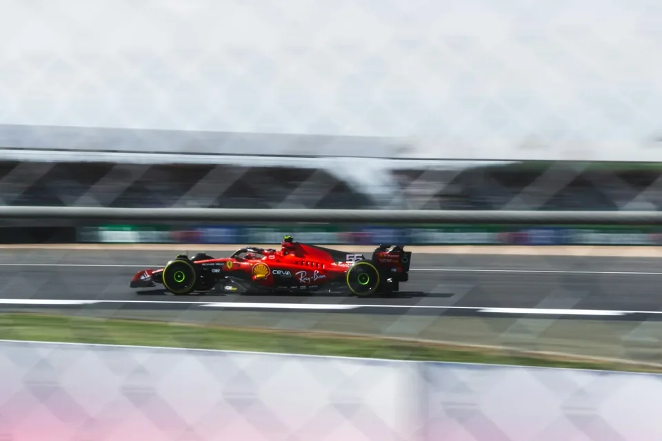 Ferrari Formula 1 car photographed through trackside fencing