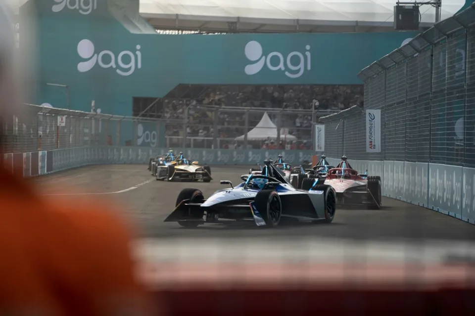 Formula E car racing through a street circuit