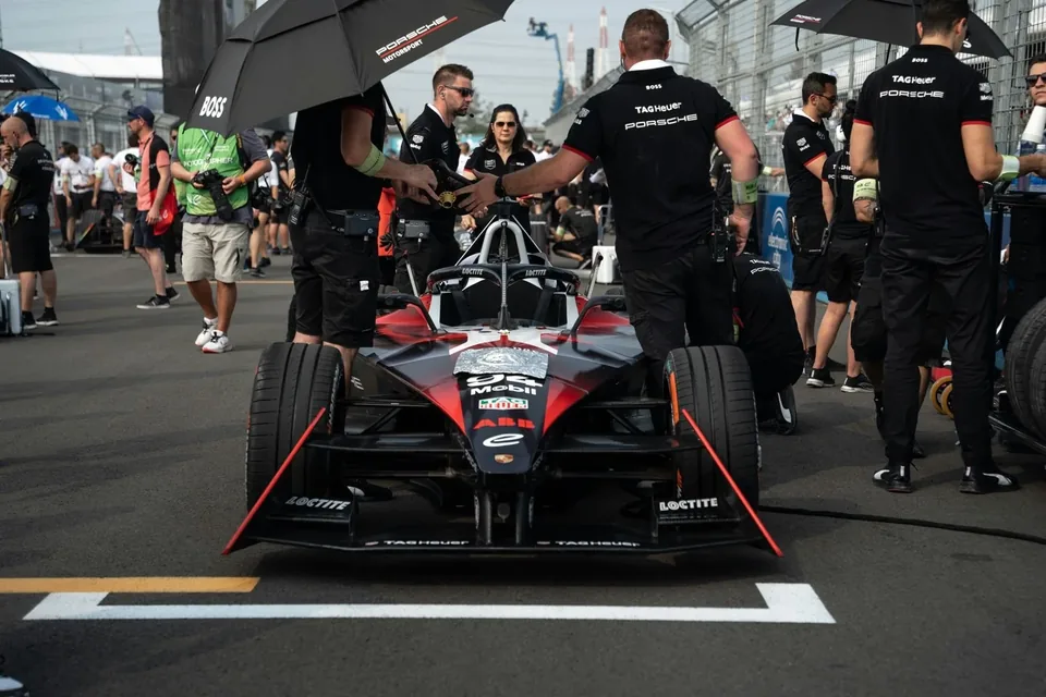 Porsche Formula E car with team members
