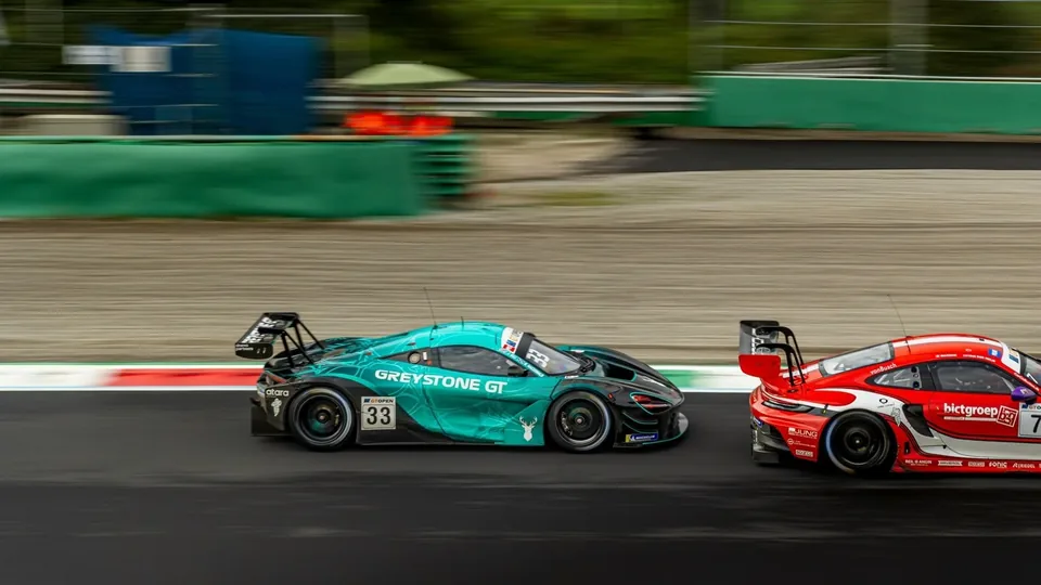Two GT race cars competing wheel to wheel