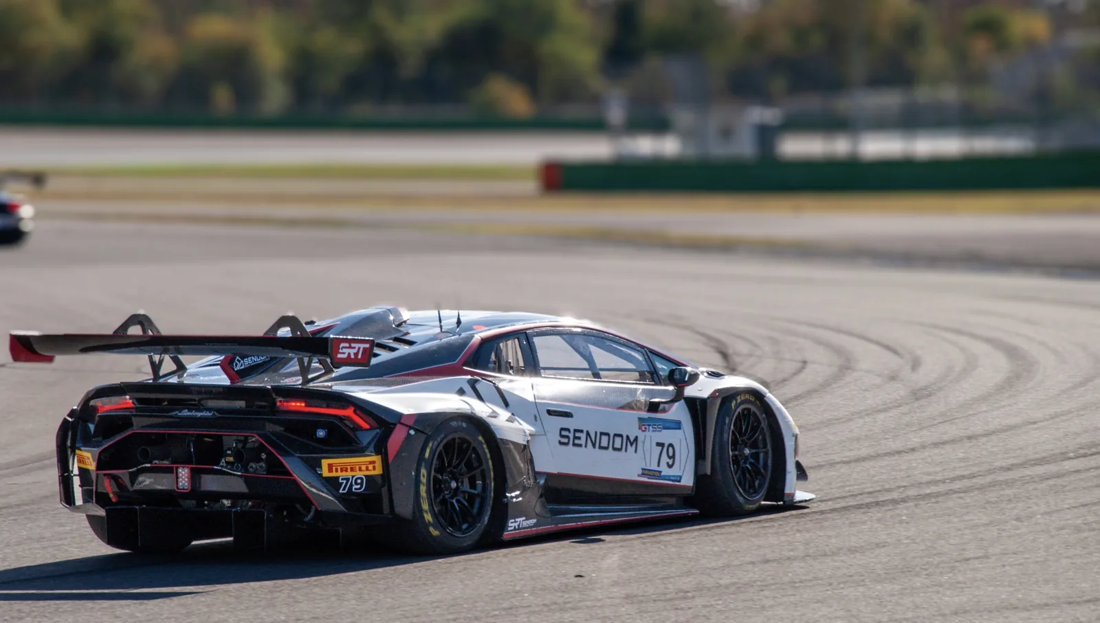 White and black number 79 Lamborghini Huracán GT3 cornering on track