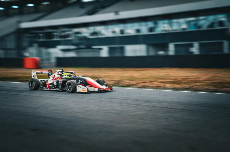 Panning shot of a single-seater at speed with the background blurred into streaks