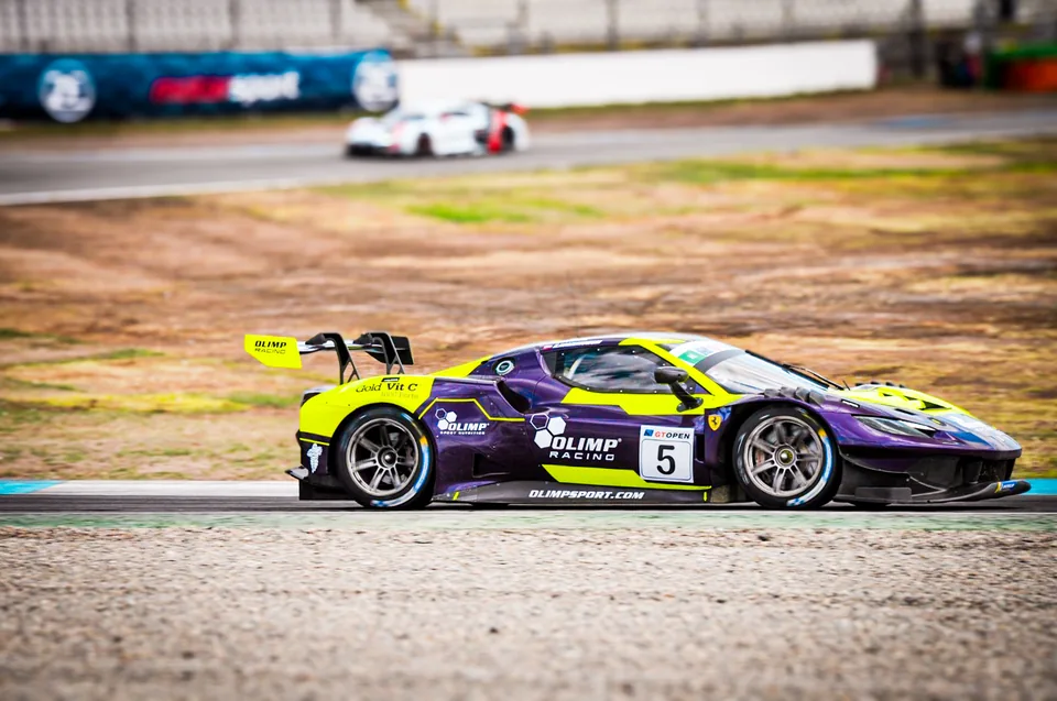 Purple and yellow number 5 Ferrari 296 GT3 in profile on track