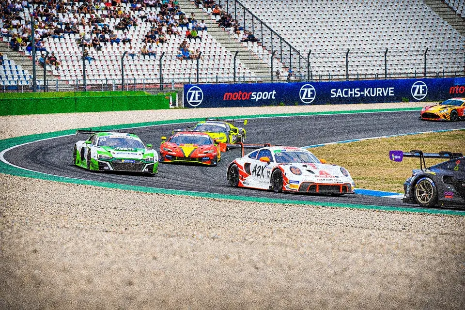 Number 12 Porsche 911 GT3 R alongside an Audi R8, a Corvette and an Aston Martin through a corner